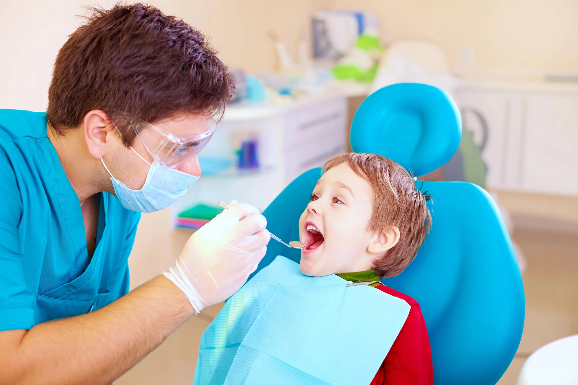 Dentist checking young boy’s teeth Family Dentist in North Charleston